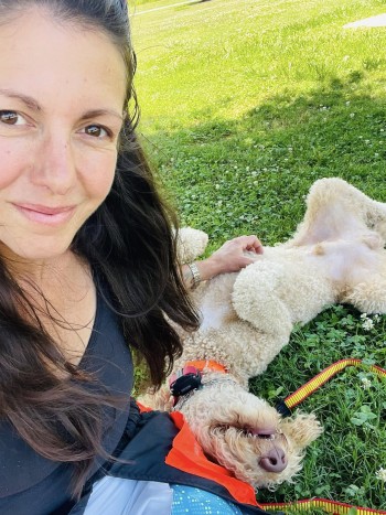 Tyler with a dog laying in the grass