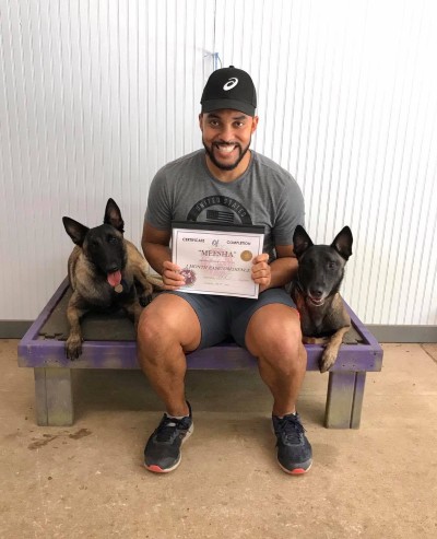 Chris with his two Belgian Malinois females Naga (training alumni) + Meesha (Graduate!) Man with his two dogs